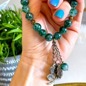Beaded bracelet with jade stones and charms